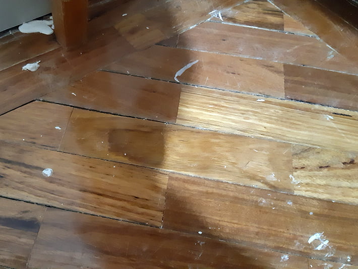 Flood damage and water damaged floorboards